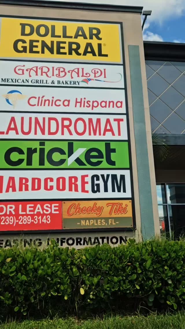 The roadside plaza sign on the Tamiami Trail with the Cheeky Tiki panel at the bottom
