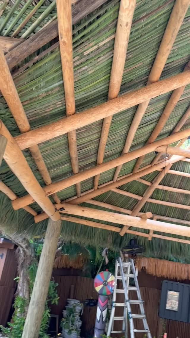 Looking up at the hand-built thatch and cypress framework of the tiki roof